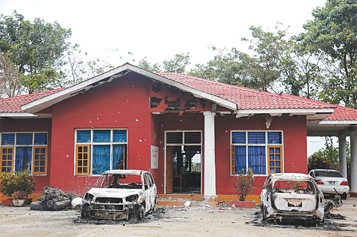 Nawnghkio: Burned vehicles stand in front of a destroyed narcotic police office on Thursday.—Reuters