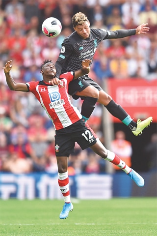 SOUTHAMPTON: Southampton’s Moussa Djenepo (L) vies for the ball with Liverpool’s Alex Oxlade-Chamberlain during the English Premier League match at St Mary’s Stadium on Saturday.—AFP