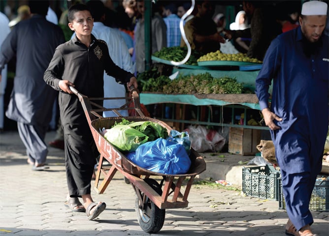 Though the ban on plastic bags came into force on Aug 14, people were still using them at the government-run Sunday bazaar in H-9. — Photo by Mohammad Asim