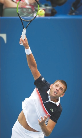 WINSTON-SALEM: Filip Krajinovic of Serbia plays a return serves to Czech Republic’s Tomas Berdych during their Winston-Salem Open match.—AP