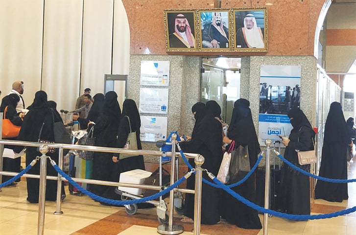 DAMMAM (Saudi Arabia): Women are seen in line at a railway station here on Wednesday. The kingdom has begun implementing a landmark reform allowing women over the age of 21 to receive passports and travel without permission from a male ‘guardian’.—Reuters