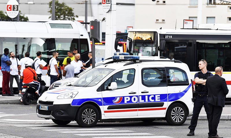 A police officer stands guard as people gather in Villeurbanne on the ouskirts of Lyon, south-eastern France on August 31, 2019. — AFP A police officer stands guard as people gather in Villeurbanne on the ouskirts of Lyon, south-eastern France on August 31, 2019. — AFP
