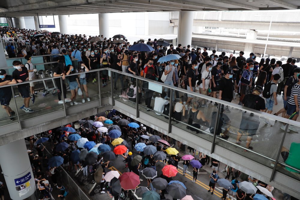 Pro-democracy protestors gather outside the airport in Hong Kong on Sunday. ─ AP
