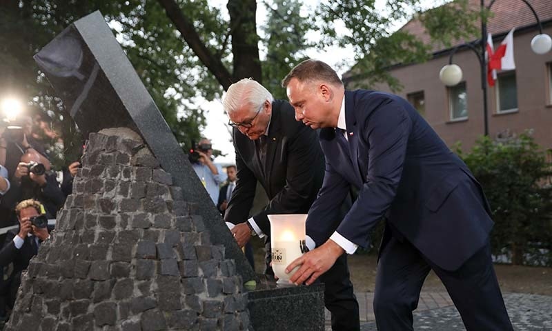 German President Frank-Walter Steinmeier (2ndR) and Polish President Andrzej Duda light candles at a memorial as part of the commemorations marking 80 years since the outbreak of World War II on September 1 in Wielun, Poland. —  Alik KEPLICZ/POOL/ AFP