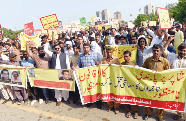 Traders protest outside the National Press Club on Tuesday. &mdash; Photo by Tanveer Shahzad