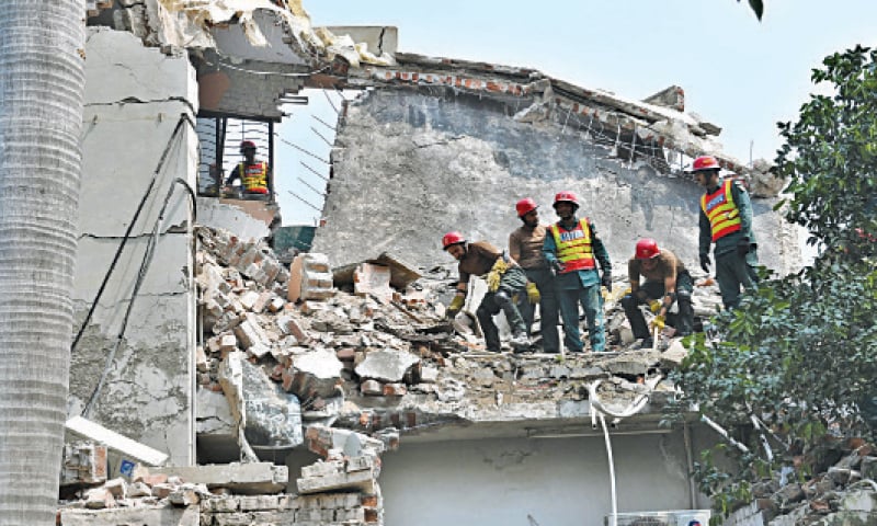 Rescue workers remove debris of the house to recover the family members after an oxygen cylinder blast in Iqbal Town. &mdash; White Star
