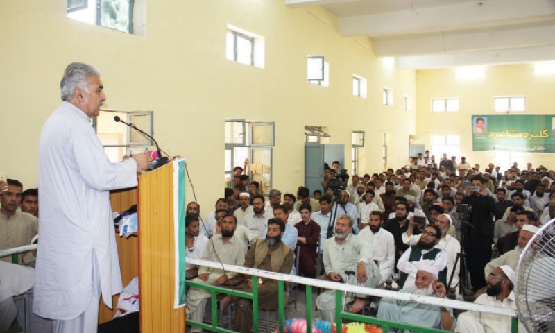 Poet Prof Abaseen Yousafzai recites his verses in Bisham on Monday. — Dawn