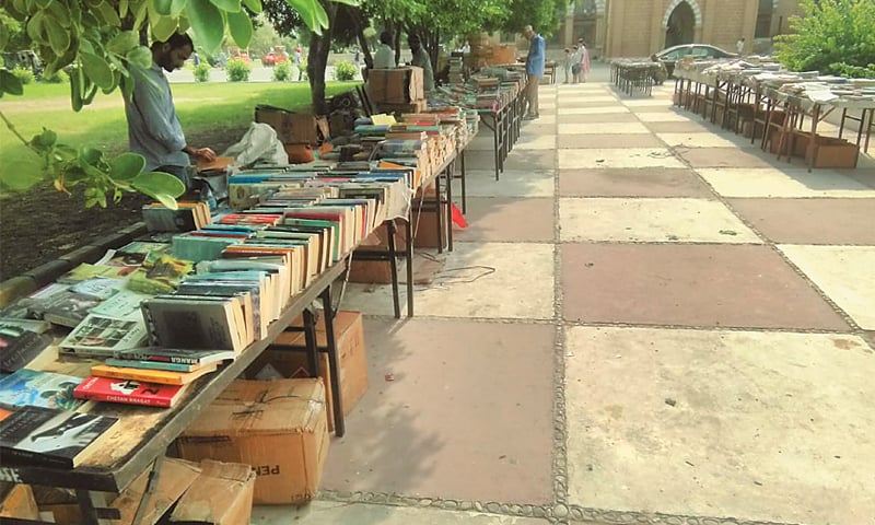 BOOKSELLERS protect themselves from the blazing sun under the shade of trees at Frere Hall.—Photo by writer