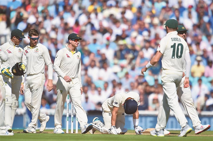 LONDON: England opener Joe Denly doubles over after being hit by a ball in the midriff during play on the third day of the fifth Test against Australia at The Oval.—AFP