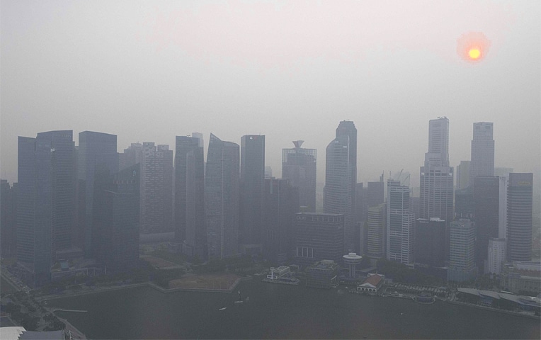 SINGAPORE: Buildings pictured after a haze blanketed the skyline on Wednesday.—AFP