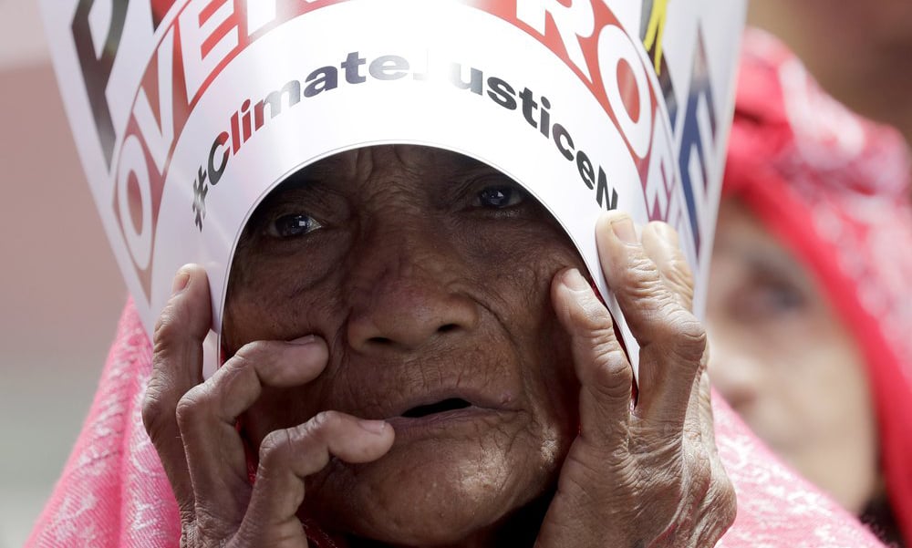 An environmental activist holds a placard during a rally outside the Department of Environment and Natural Resources to coincide with the global protests on climate change on Friday, at suburban Quezon city, northeast of Manila, Philippines. — AP An environmental activist holds a placard during a rally outside the Department of Environment and Natural Resources to coincide with the global protests on climate change on Friday, at suburban Quezon city, northeast of Manila, Philippines. — AP