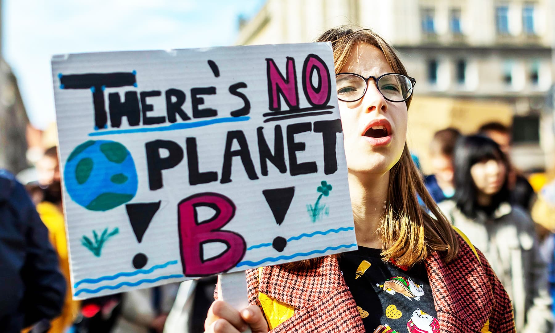 A young demonstrator holds placard reading "There's no planet B" as she takes part in a "Fridays For Future" demonstration calling for climate action in the streets of Warsaw.— AFP