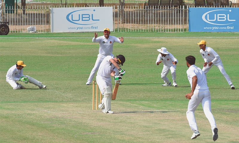 KARACHI: Sindh&rsquo;s slip cordon celebrates as Khyber Pakhtunkhwa opener Israrullah is caught by wicket-keeper Mohammad Hasan off paceman Sohail Khan during the Quaid-e-Azam Trophy match at the UBL Sports Complex on Sunday.&mdash;Tahir Jamal/White Star
