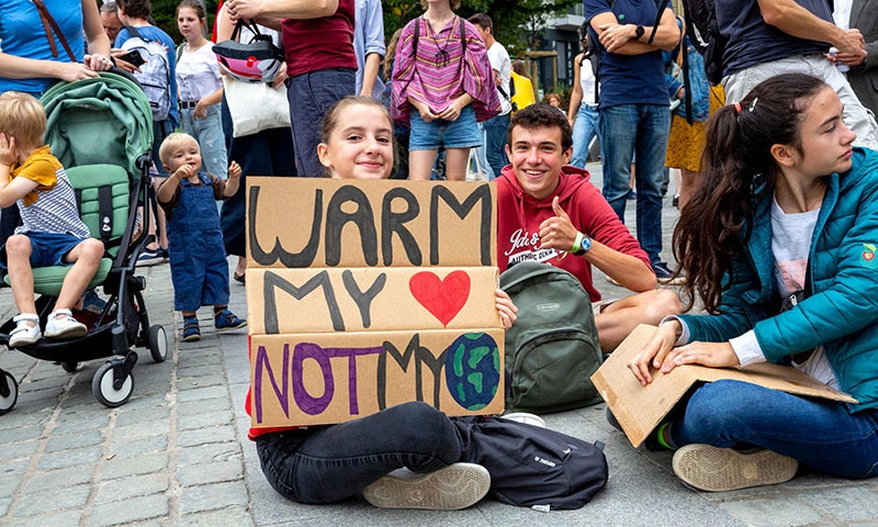 People take part in a demonstration for the climate called 'Act Now or Never' to raise awareness for climate change, organised by 'Rise for Climate Belgium', in on September 22 in Brussels. — AFP