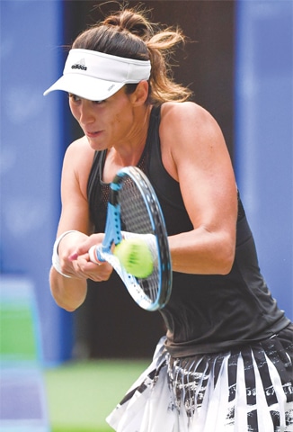 GARBINE Muguruza of Spain hits a return against Ukraine’s Elina Svitolina during their second-round match at the Wuhan Open on Tuesday.—AFP