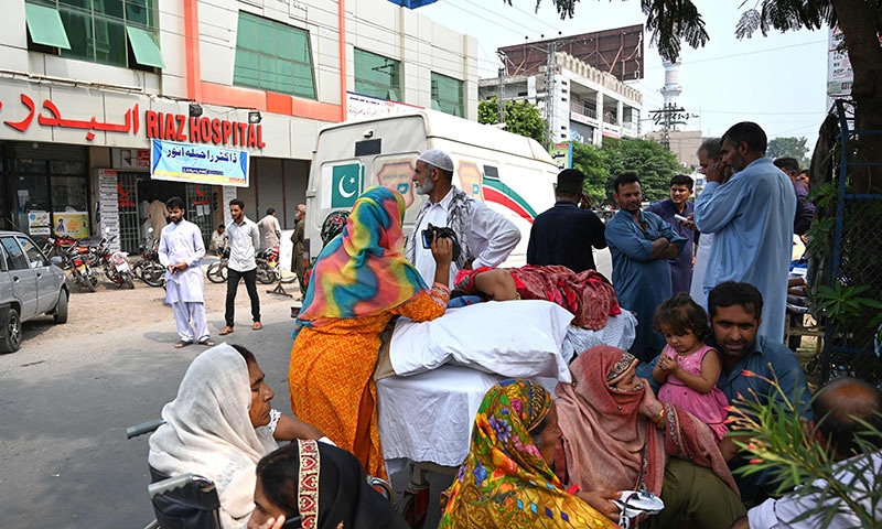 Relatives stand in a street along with patients evacuated from a hospital following a quake of 4.7-magnitude in Mirpur on Thursday. — AFP