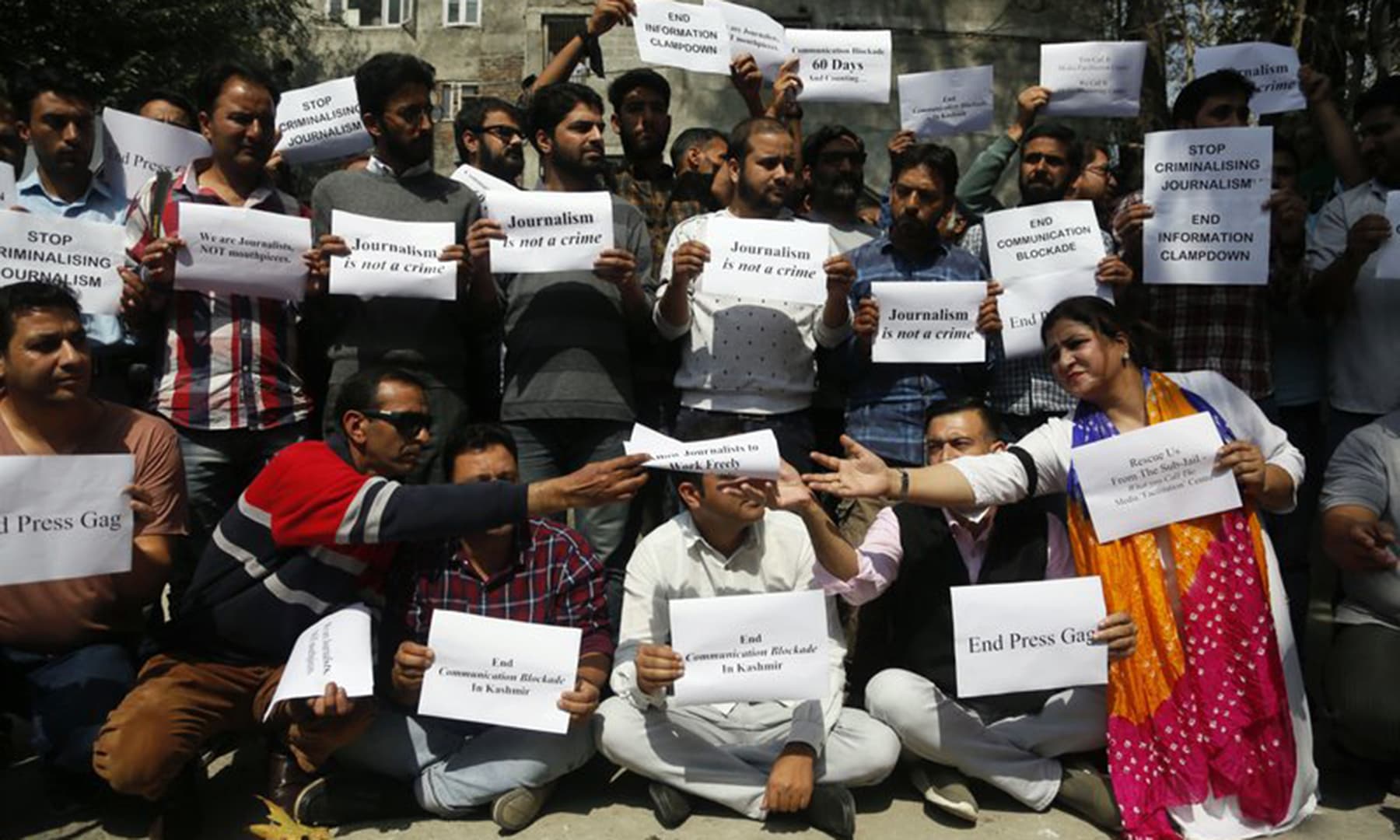 Kashmiri journalists display placards during a protest against the communication blackout in Srinagar, Thursday. — AP