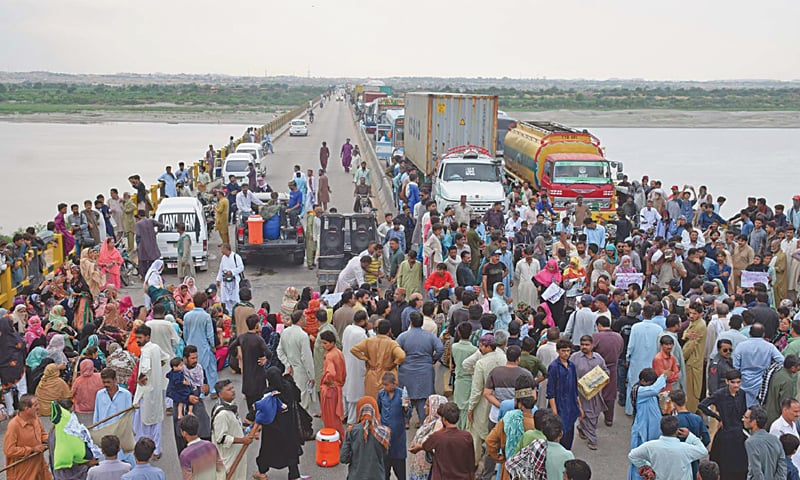 Lady health workers and their supporters block a bridge on Motorway near Hyderabad on Friday.&mdash;Dawn