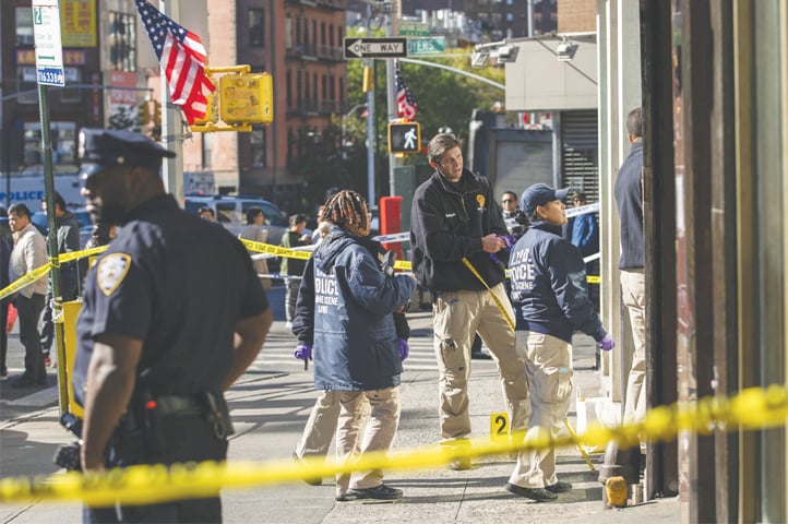 New York Police Department officers investigate the scene of an attack in Manhattan’s Chinatown neighborhood on Saturday.—AP