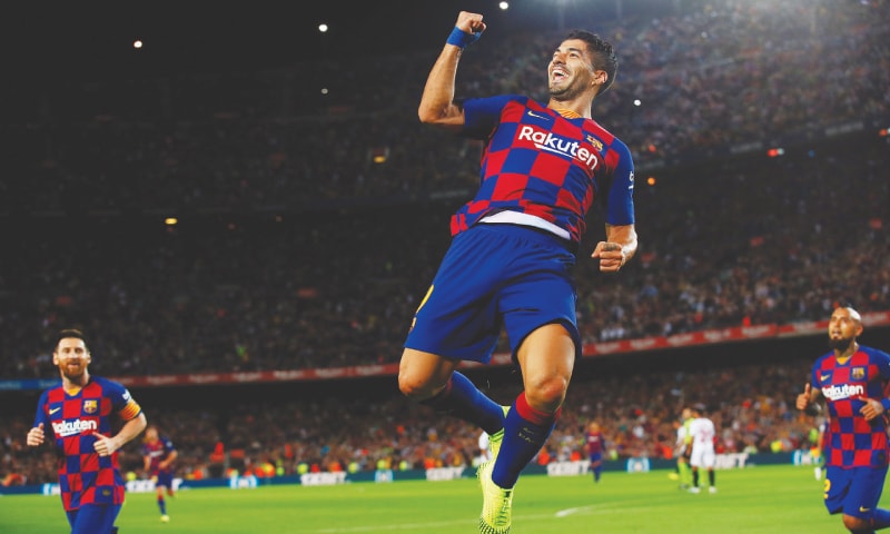 BARCELONA: Barcelona’s Luis Suarez celebrates after scoring during the La Liga match against Sevilla at Camp Nou.—Reuters