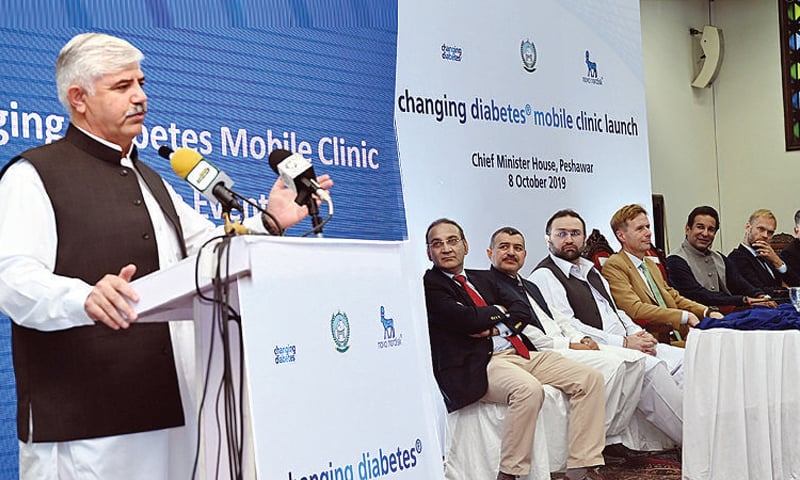 Chief Minister Mahmood Khan addresses a ceremony in Peshawar on Tuesday to inaugurate a diabetes mobile clinic. Legendary cricketer Waseem Akram, Health Minister Hasham Inamullah and others are also present. — White Star