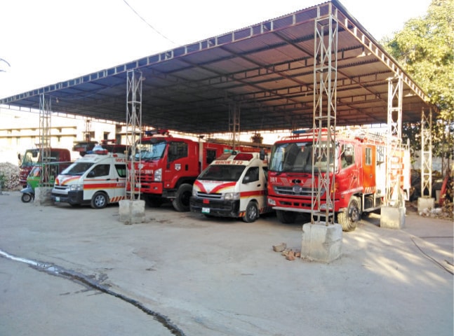 Rescue 1122 vehicles parked on tehsil municipal administration premises as a makeshift arrangement. — Dawn