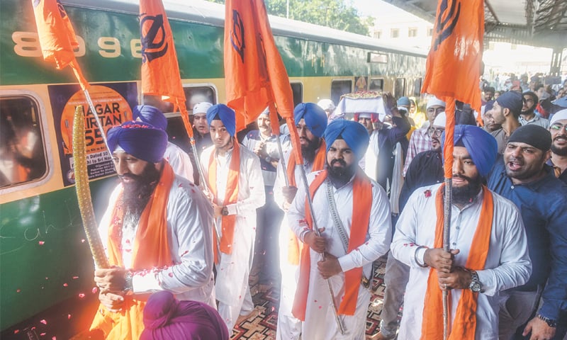 Sikh devotees carry the Guru Granth Sahib in a procession at City Station on Thursday.
—Fahim Siddiqi / White Star