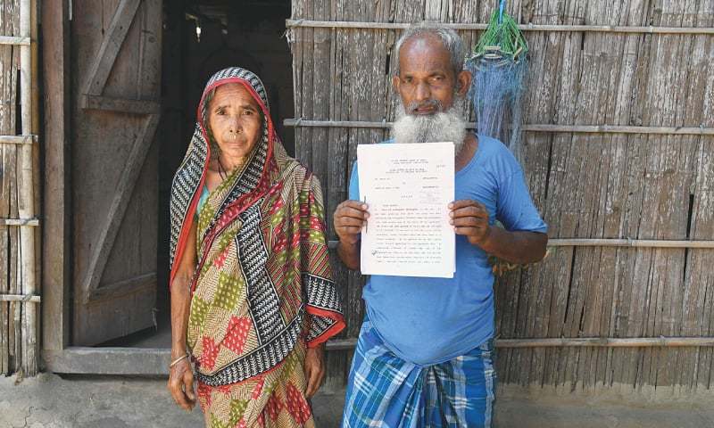 This July 1 file photo shows Mohammed Rehat Ali, 71, one of many to fall foul of a citizenship process, holding a Supreme Court of India’s order declaring him an Indian citizen. — AFP