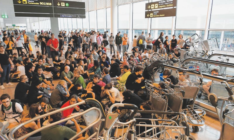 Barcelona: Protesters use trolleys to block escalators at El Prat airport on Monday as thousands of angry protesters took to the streets after Spain&rsquo;s Supreme Court sentenced nine Catalan separatist leaders.&mdash;AFP