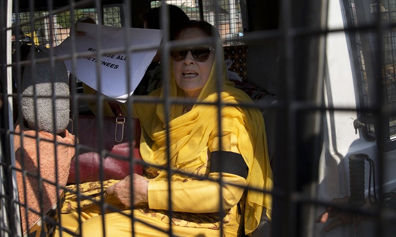 The sister of occupied Jammu and Kashmir's National Conference party leader Farooq Abdullah, holds a placard inside a police vehicle after she was detained by police in Srinagar, India-occupied Kashmir, Tuesday. — AP