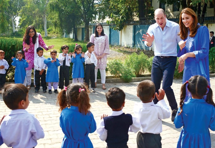 The duke and duchess of Cambridge greet schoolchildren during their visit to Islamabad Model School for Girls, Quaid-i-Azam University Colony, on Wednesday. — Photo by Tanveer Shahzad