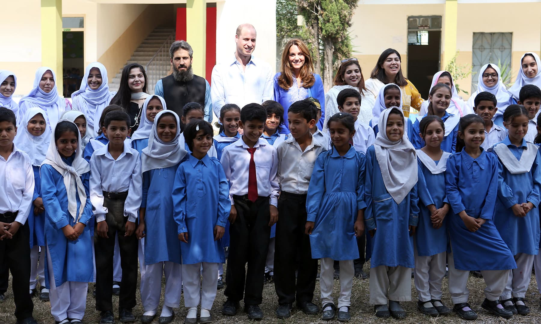 Prince William and Catherine, Duchess of Cambridge pose for a group photo with staff and students at a school during a trip to Islamabad, October 15. — Reuters