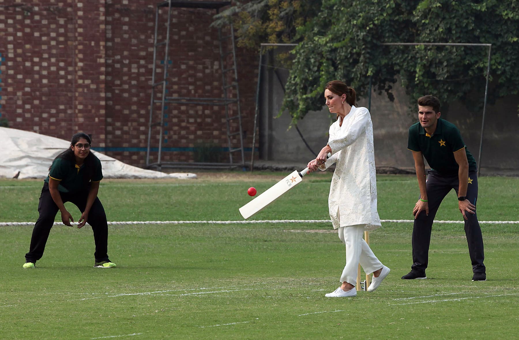 Catherine, Duchess of Cambridge, plays cricket during her visit at the National Cricket Academy in Lahore, October 17. —AFP