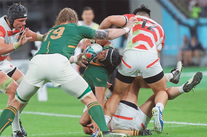 TOKYO: South Africa’s Cheslin Kolbe holds the ball against the Japan defence during their Rugby World Cup quarter-final at Tokyo Stadium on Sunday.—AP