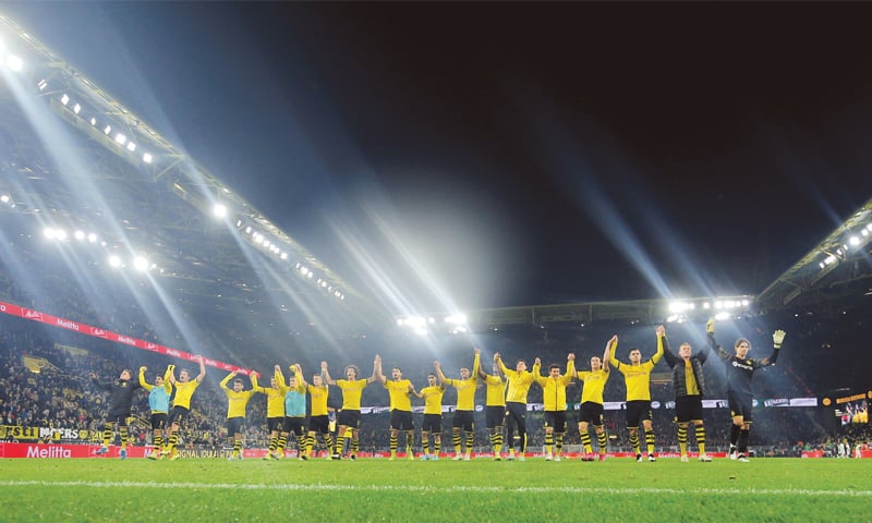 DORTMUND: Borussia Dortmund players celebrate at the end of the Bundesliga match against Borussia Moenchengladbach at Signal Iduna Park.—Reuters