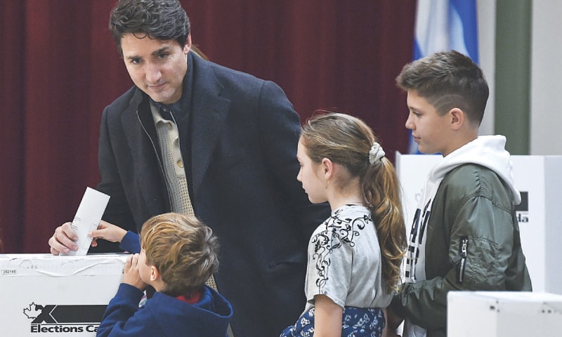 MONTREAL: Canadian Prime Minister Justin Trudeau with his three children as he votes in his district.&mdash;AFP