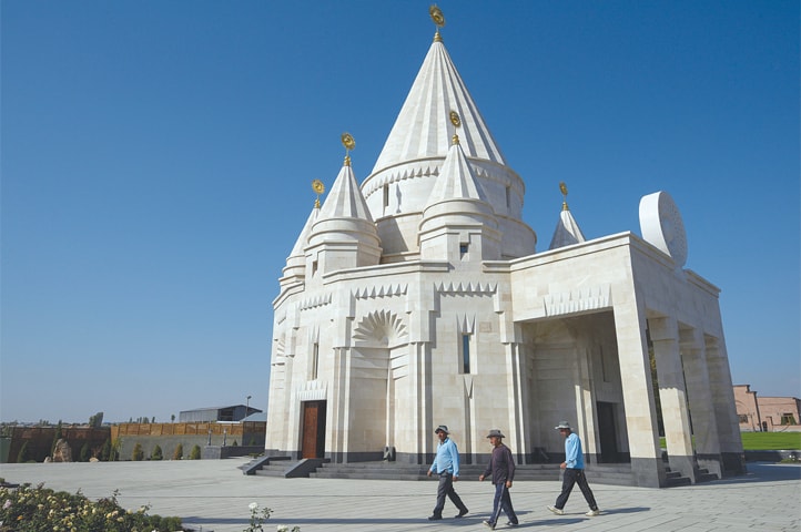 AKNALICH (Armenia): People walk past the new Yazidi temple.—AFP