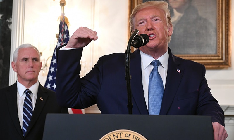 US President Donald Trump speaks about Syria in the Diplomatic Reception Room at the White House in Washington, DC, Wednesday, as US Vice President Mike Pence looks on. — AFP