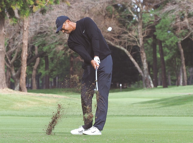 INZAI CITY: Tiger Woods of the US hits a second shot at the second hole during the first round of the Zozo Championship at the Narashino Country Club on Thursday.—AFP