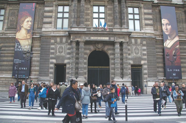PARIS: Posters of the exhibition &lsquo;Leonardo da Vinci&rsquo; are seen on the facade of The Louvre Museum on Thursday.&mdash;AFP