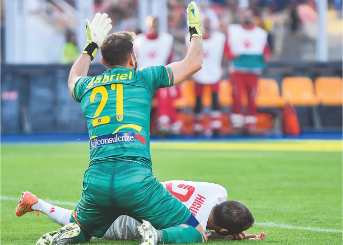 LECCE: Lecce goalkeeper Gabriel (L) calls out for staff medics&rsquo; help after he collided with Juventus&rsquo; Gonzalo Higuain during their Serie A match at the Stadio Comunlae Via del Mare.&mdash;AFP