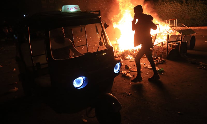 Burning tyres light up the night skies during anti-government protests in the Shiite shrine city of Karbala, south of Iraq's capital Baghdad, late on October 28, 2019. &mdash; AFP