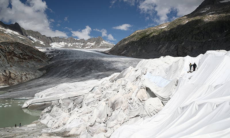 People enter the Ice Cave, covered with material to prevent the ice from melting, at the Rhone Glacier at the Furka, Switzerland, August 21, 2019. — Reuters People enter the Ice Cave, covered with material to prevent the ice from melting, at the Rhone Glacier at the Furka, Switzerland, August 21, 2019. — Reuters