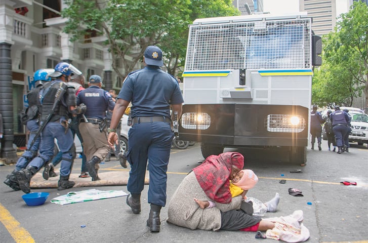 CAPE TOWN: A woman carrying her baby protests outside the UN refugee agency’s offices.—AP