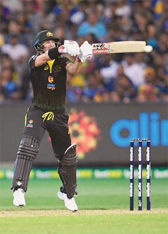 AUSTRALIAN opener David Warner hits out during the final Twenty20 International against the Sri Lanka at the MCG on Friday.—AFP