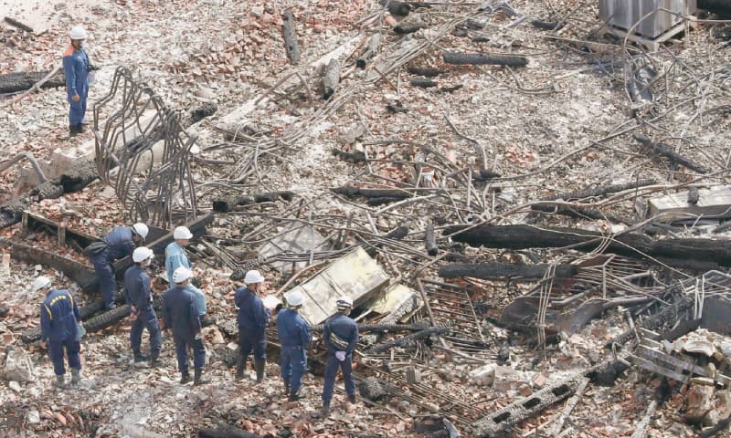 NAHA (Japan): Investigators work at the site of the fire on historic Shuri Castle in Okinawa on Friday.&mdash;AP