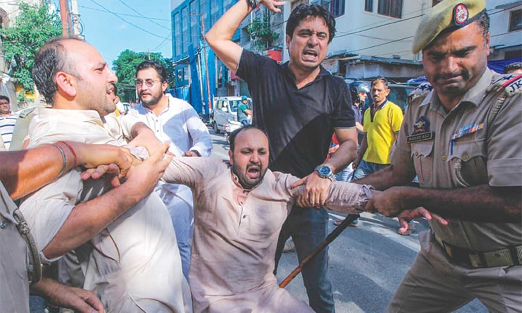 Police taking an activist of Jammu and Kashmir Youth Congress into custody during a protest against the Indian government on Aug 10. — AFP