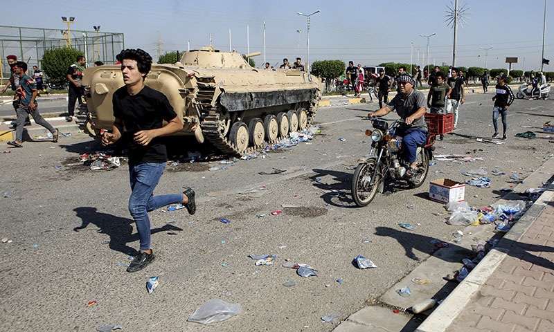 Anti-government protesters block the port of Umm Qasr while Iraqi security forces try to reopen the key oil terminal on the Persian Gulf, Iraq, Tuesday, Nov. 5. — AP