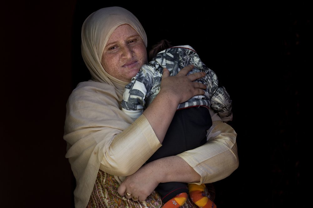 In this Oct 17 photo, a Kashmiri woman Zahida Jahangir holds her two-month-old son Mohammad Taimor and stands for a photograph inside their home in Lolab, about 128 kilometers (80 miles) north of Srinagar. Taimor was born premature and put on a ventilator in a children’s hospital while Zahida was receiving treatment in another hospital. Because of the lockdown, there was no way to tell Zahida when her son was ready for breastmilk so the hospital settled for milk supplement. Zahida was reunited with Taimor 20 days after he was first put on a ventilator. ─ AP