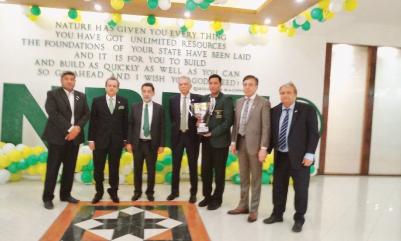 KARACHI: Cueist Mohammad Asif holds his World Snooker trophy as he is seen with NBP President Arif Usmani, Sports Head Iqbal Qasim and other officials on Tuesday.